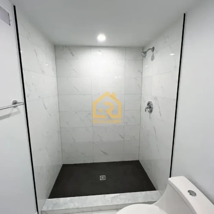 clean bathroom featuring a modern shower 700x700
