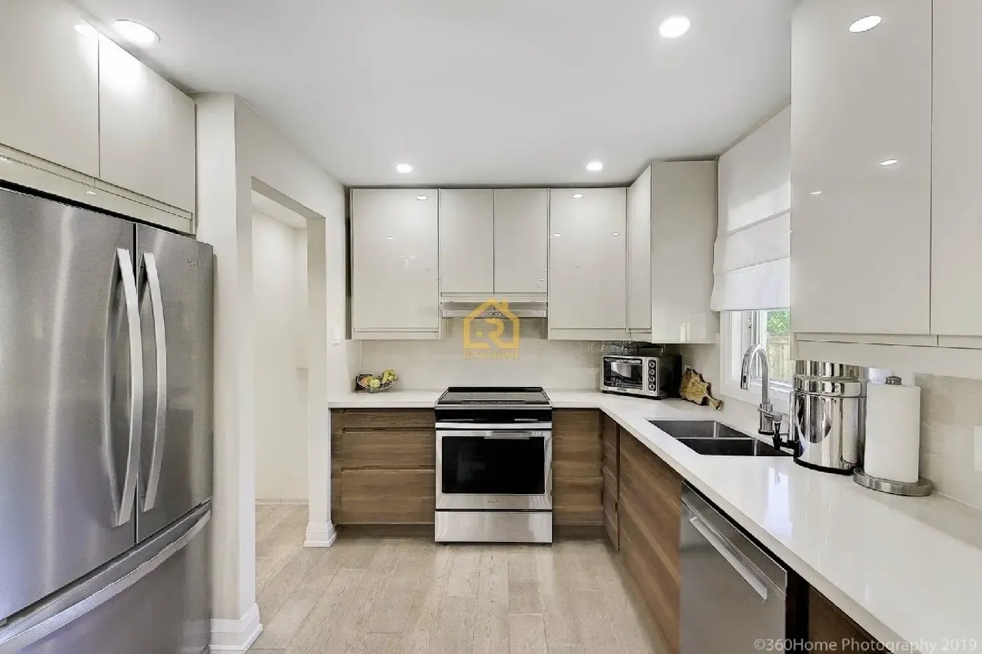 rich home modern kitchen featuring stainless steel appliances and sleek white cabinets 1