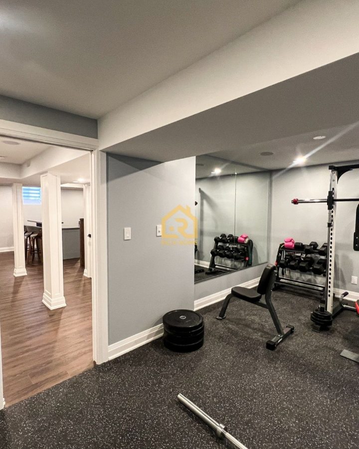basement gym with mirrored wall lighting